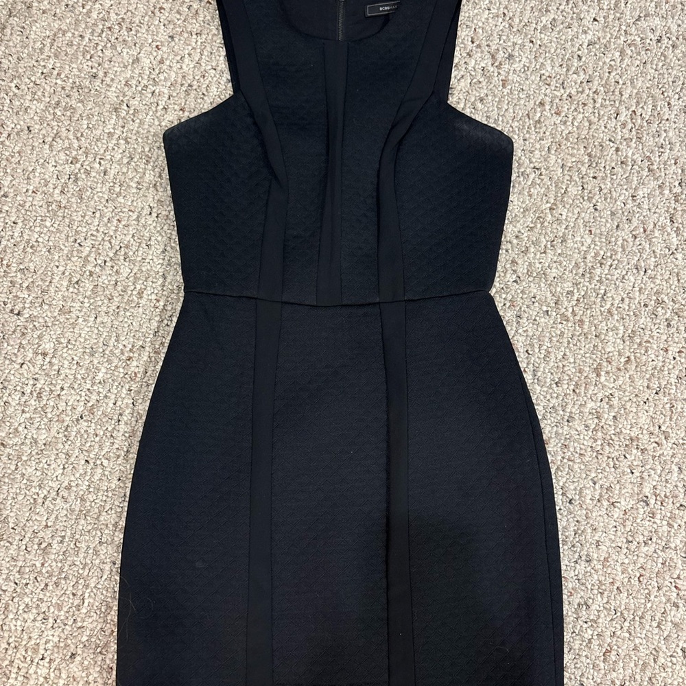 BCBG Max Azria Avina black cocktail dress with a subtle quilted pattern.